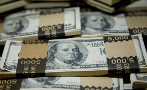 A pile of bank bound Benjamin Franklin $100 bills in stacks of $5000.